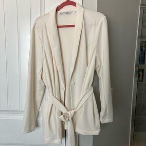 Girl with curves cream colored blazer.